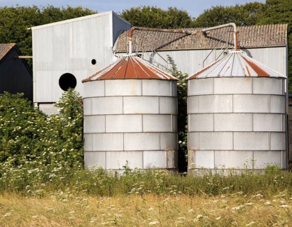Old steel storage tanks and barns, West Kennet, Wiltshire, England, UK