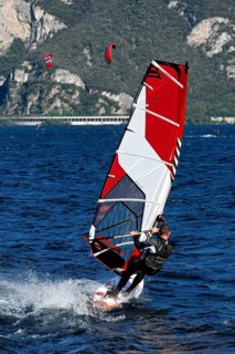 Windsurfers surfing in strong winds on Lake Garda near Malcesine, Veneto, Italy, Europe