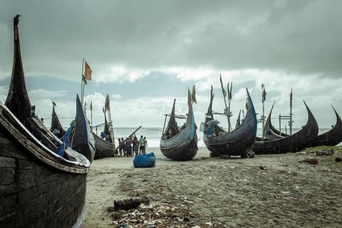 Fishing boats on the beach during a monsoon shower, Cox's Bazar, Bangladesh, Asia