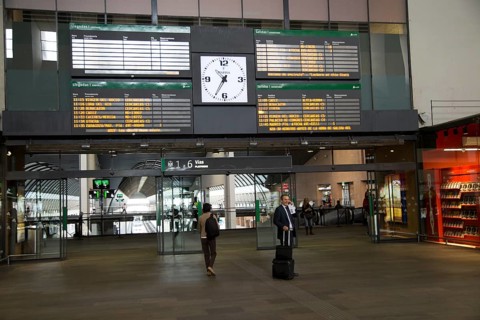 Electronic clock and display of travel information inside Santa Justa railway station, Seville,