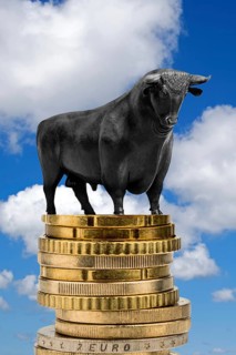 Bull market, bull on euro coins, cumulus clouds in front of blue sky, East Frisia, Lower Saxony,