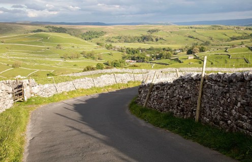 Country lane and dry stonewalls, Malham, Yorkshire Dales national park, England, UK
