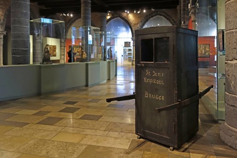 Medieval ambulance, sedan chair in the old sick-bay at the medieval Sint-Janshospitaal, St John's