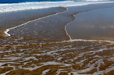 Wave breaking on sandy beach at Conil de la Frontera, Cadiz Province, Spain, Europe