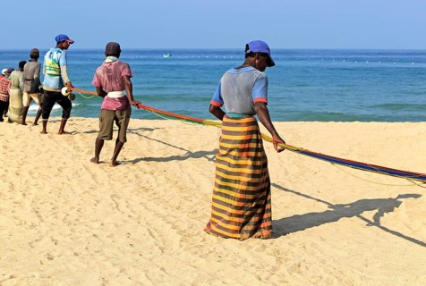 Traditional fishing hauling nets Nilavelli beach, near Trincomalee, Eastern province, Sri Lanka,
