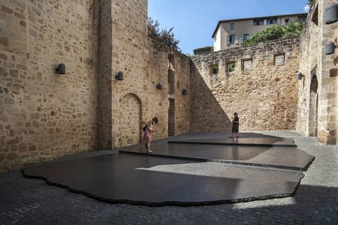 Tourists visiting giant replica of the Rosetta Stone that allowed Jean-Francois Champollion to