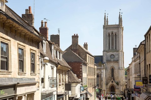 St. Michael's Church tower and buildings in Ironmonger Street, Stamford, Lincolnshire, England, UK