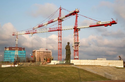 Cranes tower over statue of S.W.R.D. Bandaranaike at construction site in central Colombo, Sri