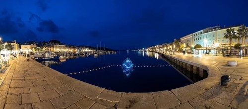 Blue hour, harbour of Mali Losinj, illuminated Christmas tree in the harbour basin, panoramic shot,