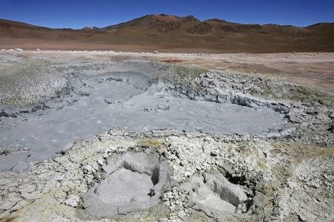 Mud lakes and steam pools with boiling mud in geothermal field Sol de Manana, Altiplano, Bolivia,