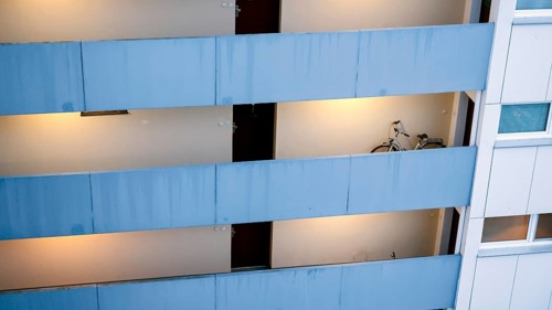 A bicycle stands in an open hallway in a tower block in Gropiusstadt. The rise in rents in German