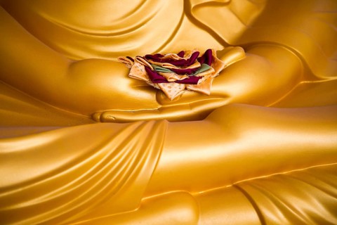 Detail of Buddha statue with offering in palm of hands, Gangaramaya Temple, Colombo, Sri Lanka,
