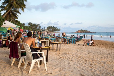 People sitting at tables of beach bar, Mirissa, Sri Lanka, Asia