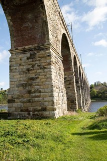Stone arches of railway viaduct crossing River Tweed, Berwick-upon-Tweed, Northumberland, England,