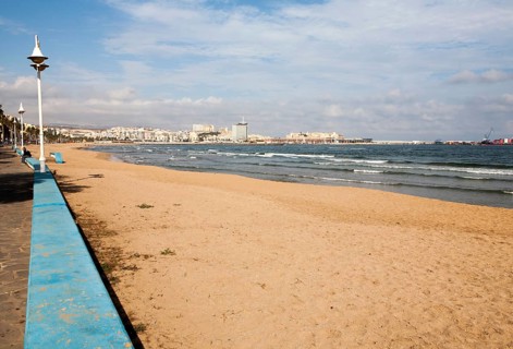 Sandy beach with view to historic walled fort of Melilla la Vieja, Melilla autonomous city state