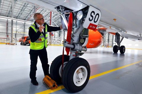 Olaf Gross, Licence Engineer at easyJet, checks the landing gear of an Airbus A320 Neo in front of