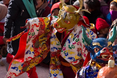 A monk performing cham, the sacred religious masked dance, during the Spituk Gustor winter festival