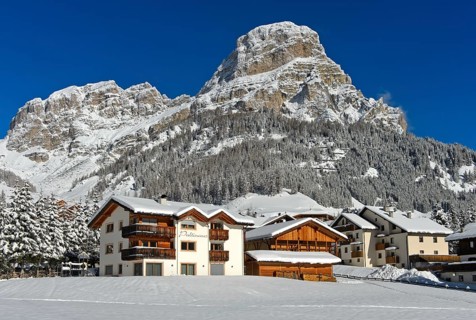 The snow-covered hamlet of Colfosco, Colfosco, at the foot of the Sassongher peak, Colfosco,