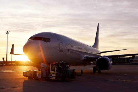 Airbus aircraft towing with push back vehicle in the sunset, Munich Airport, Upper Bavaria,