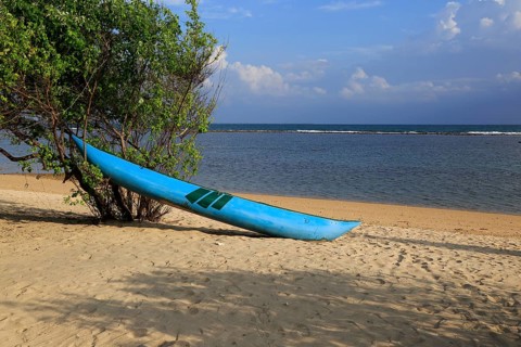 Canoe on sandy tropical beach at Pasikudah Bay, Eastern Province, Sri Lanka, Asia