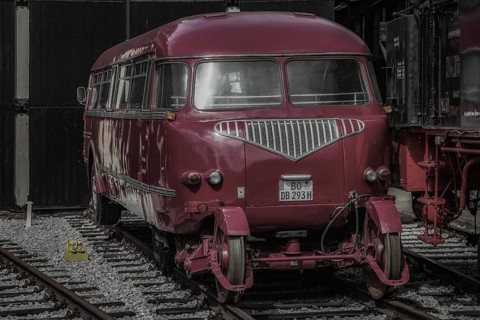 A red vintage rail bus parked on railway tracks in a museum, Dahlhausen railway depot, Lost Place,