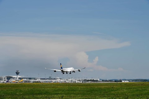 Lufthansa Airbus A340 landing on southern runway, with thundercloud and storm front in the