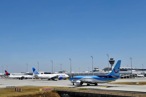 TUI Boeing B737-800 MAX taxiing on apron in front of Terminal 1 with tower, Munich Airport, Upper