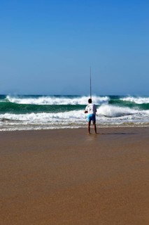Man fishing from the beach at Conil de la Frontera, Cadiz province, Spain, Europe