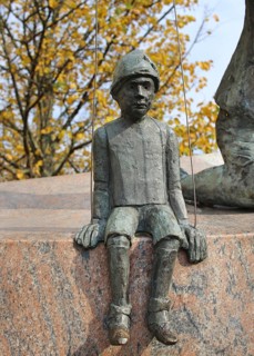 Part of the comic mask sculpture in Bialystok. Stone theater doll. Bialystok, Poland, Europe