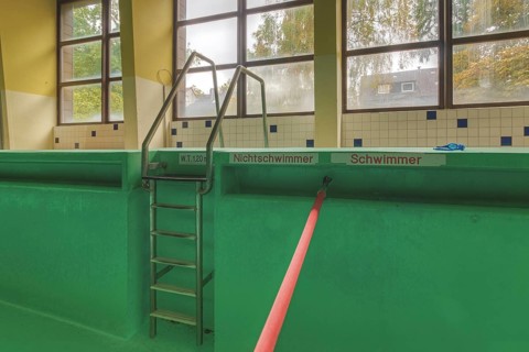Abandoned swimming pool with signs for non-swimmers and swimmers' areas, Bad am Park, Lost Place,