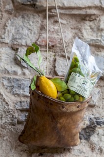 House facade with decoration and advertising, leather bag with lemon and olives, Limone sul Garda,