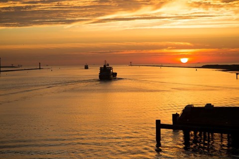 Sunset orange glow landscape clouds water, North Sea shipping, Port of Rotterdam, Hook of Holland,
