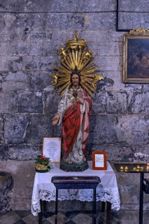 Chistus figure with sacrificial candles in the church of San Donato, 12th century, Via S. Donato,