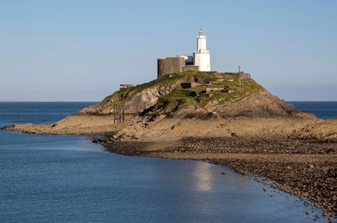 Lighthouse at low tide Mumbles Head, Gower peninsula, near Swansea, South Wales, UK
