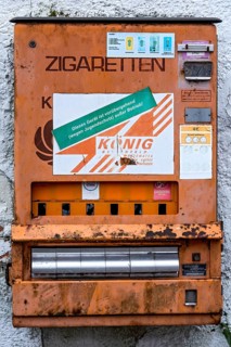 Rotten, rusty cigarette vending machine, device temporarily out of service due to youth protection,