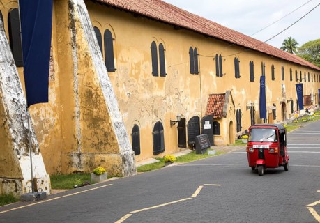 Motorised rickshaw by fort walls inside the historic town of Galle, Sri Lanka, Asia