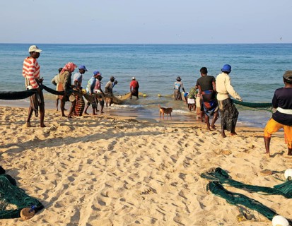 Traditional fishing hauling nets Nilavelli beach, near Trincomalee, Eastern province, Sri Lanka,
