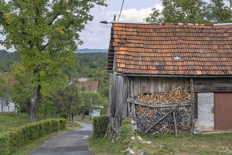Stack of firewood piled up against wall of wooden shed in rural Croatia, Karlovac County,