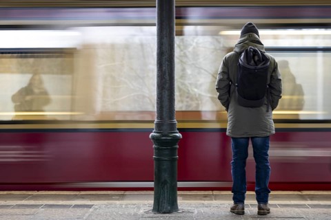 A man stands at Friedrichshagen S-Bahn station while the S-Bahn arrives. Today is the second day of