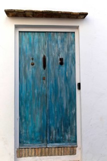 Blue doorway traditional whitewashed buildings in Vejer de la Frontera, Cadiz Province, Spain,