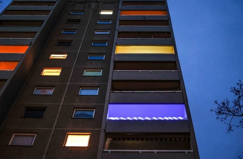Illuminated flats and balconies in a tower block in Gropiusstadt. The rise in rents in German