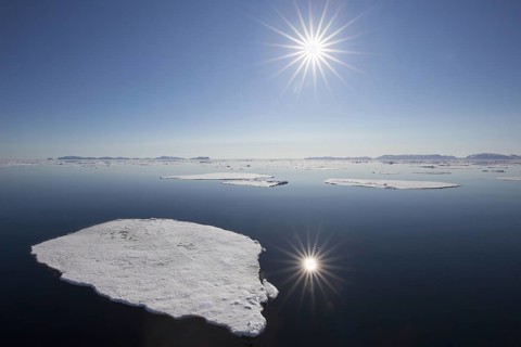 Midnight sun over the Arctic Ocean with drifting ice floes, north of the Arctic Circle at