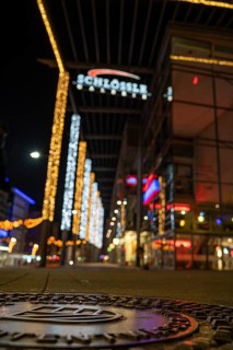 Shallow depth of field shows city lights and neon signs at night, Schloessle Galerie, Pforzheim,