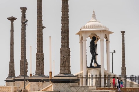 Child at the foot of a Mahatma Gandhi monument, statue, former French colony of Pondicherry or
