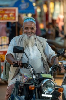 Muslim man on motorbike, bazaar, at Charminar, Hyderabad, Andhra Pradesh, India, Asia