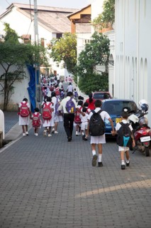 School girls in uniform walking in a street in the historic town of Galle, Sri Lanka, Asia