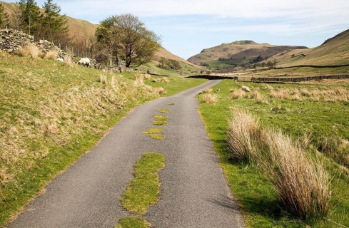 Narrow road and dry stonewall, Boredale valley, Martindale, Lake District national park, Cumbria,