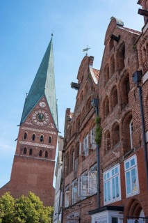 Historic town houses and merchants' houses, gables of traditional brick buildings, and tower of St