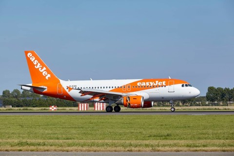 EasyJet Airbus A319-111 with registration G-EZDI lands on the Polderbaan, Amsterdam Schiphol