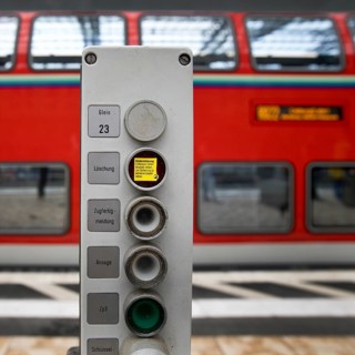 Railway technology on track 23 in front of a blurred double-decker local train, Frankfurt am Main